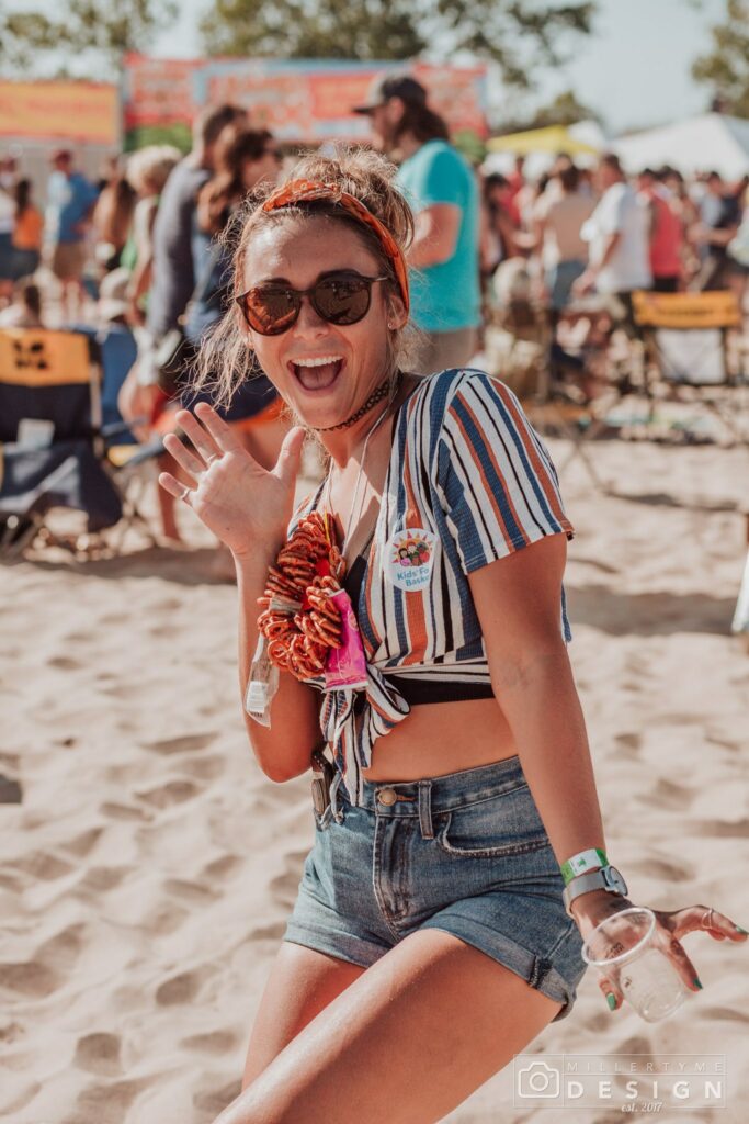 Image of a girl showing off her Pretzel necklace at Burning Foot Beer Fest